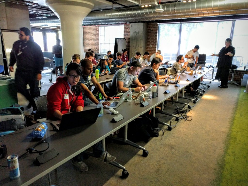 a picture of Emily 'Nexxy' Rose leading a focused workshop on Node and hardware
